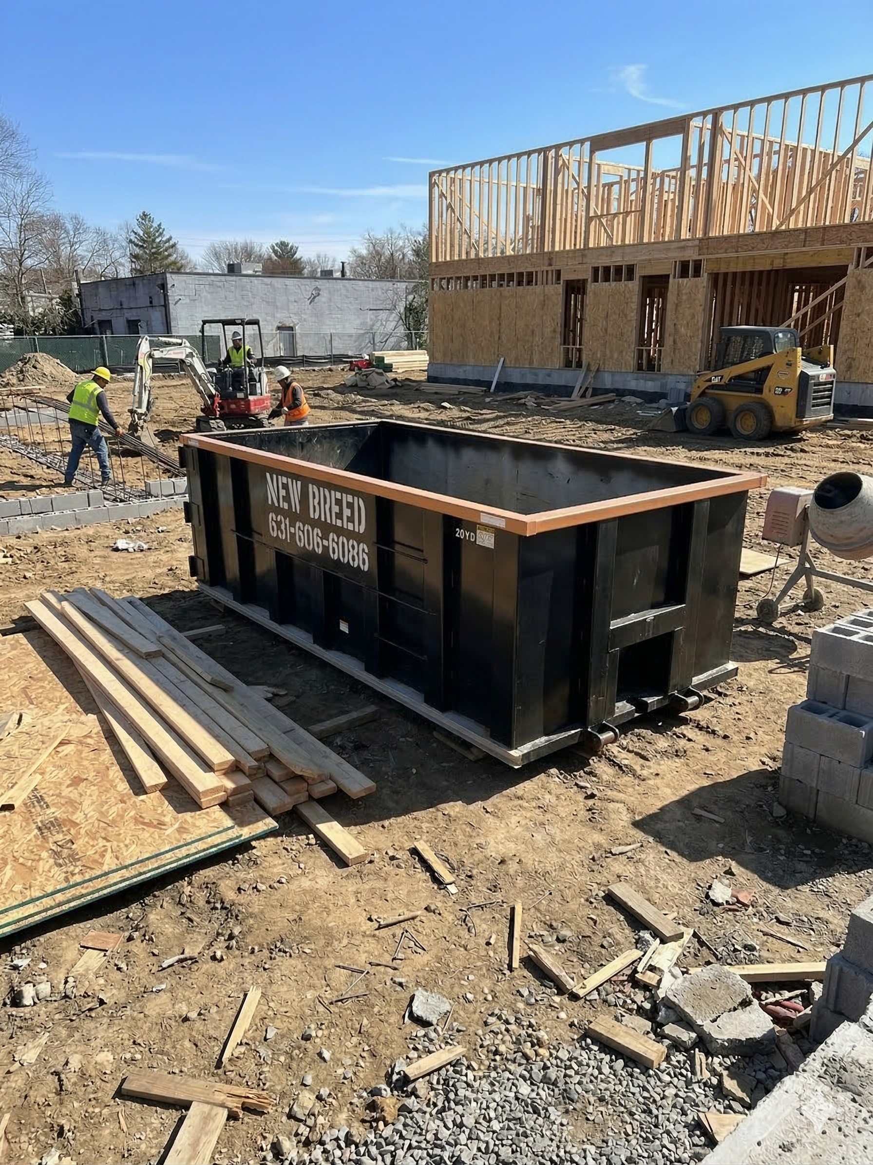 New Breed Haulage 20-yard roll-off dumpster at a Long Island construction site