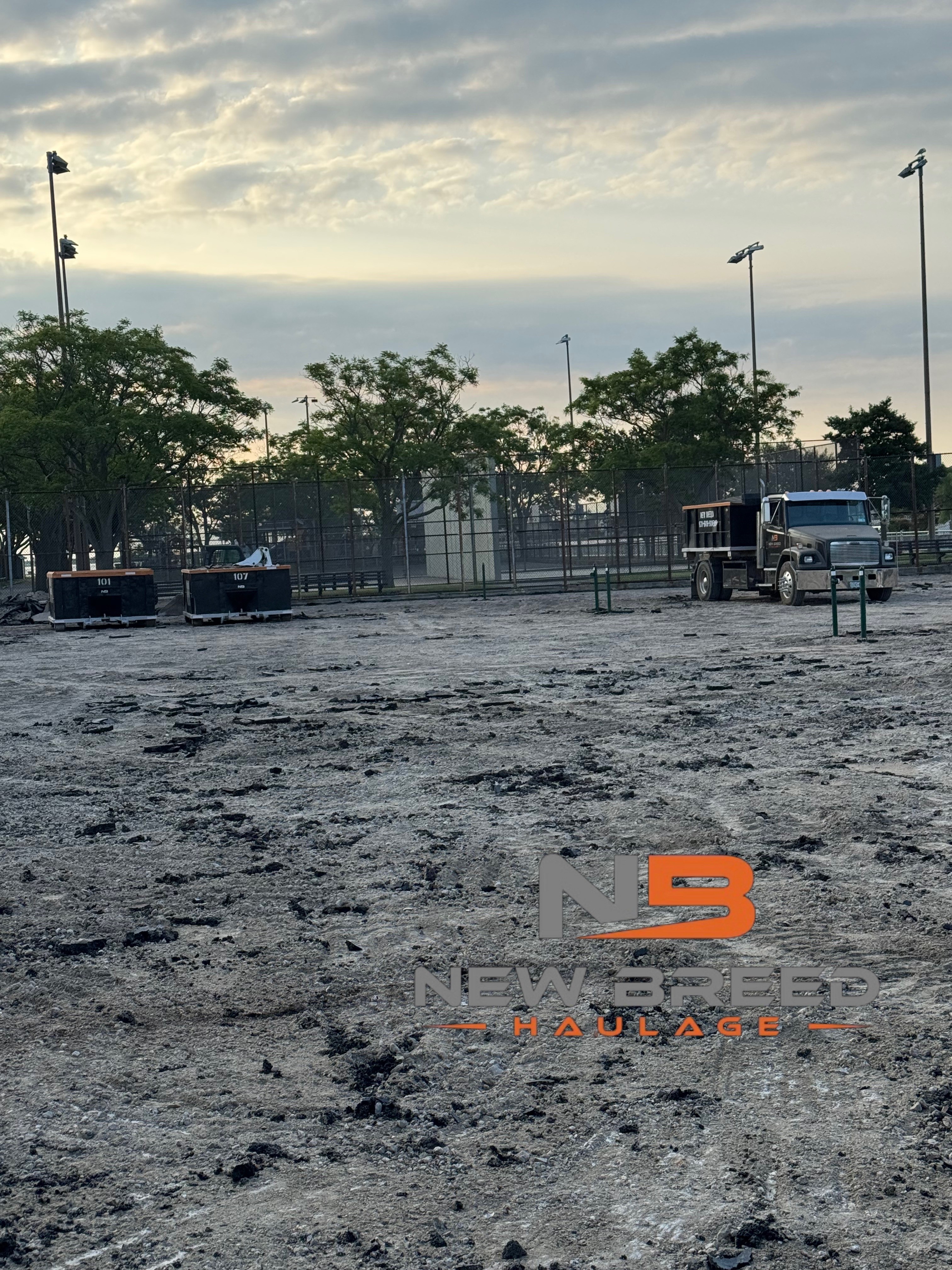 New Breed Haulage dumpsters staged at a Long Island job site at dusk